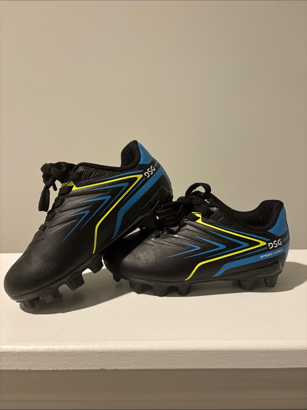 DSG Boy’s Black Athletic Cleats with Blue and Yellow Trim